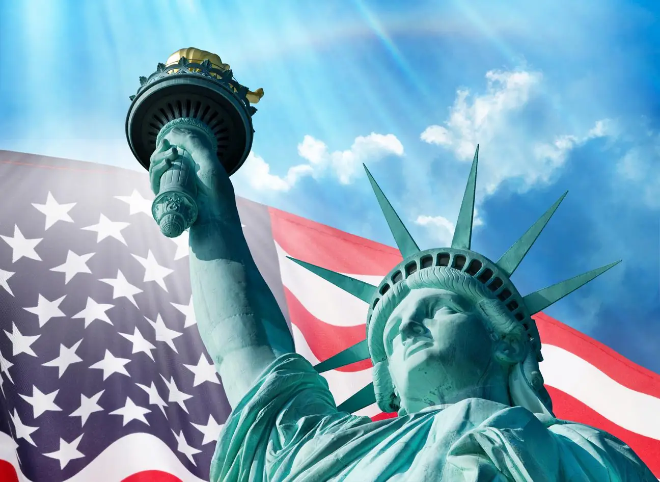 Statue of Liberty and American Flag Under Blue Sky